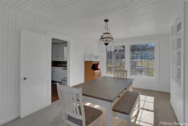 a view of a dining room with furniture window and outside view