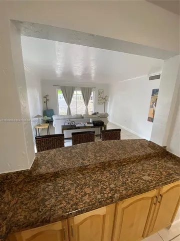 a view of a room with wooden floor and furniture