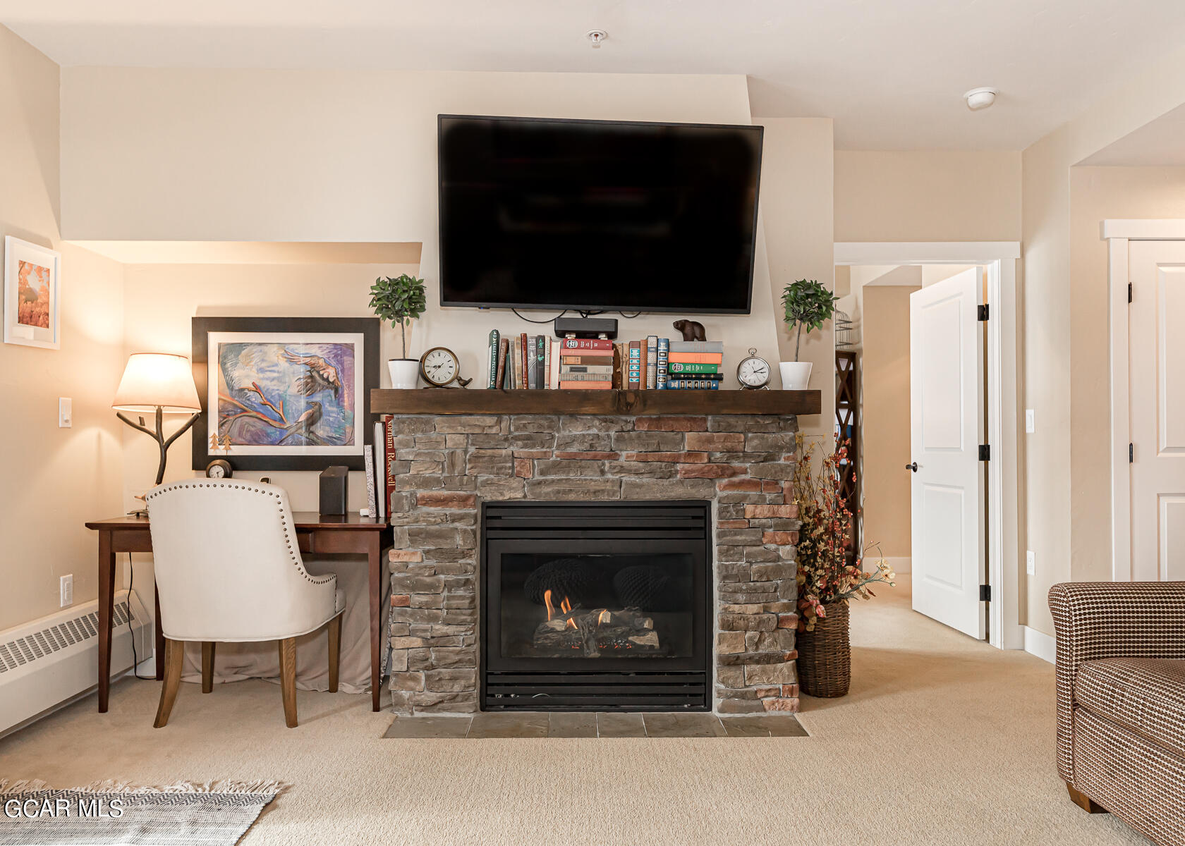 300 Base Camp Circle, Unit 208 Granby, CO 80446 - Photo 11 of 66 a living room with furniture a fireplace and a flat screen tv