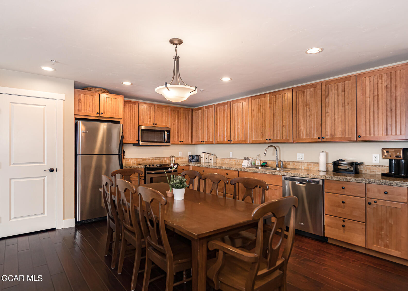 300 Base Camp Circle, Unit 208 Granby, CO 80446 - Photo 16 of 66 a view of a kitchen with a dining table and chairs