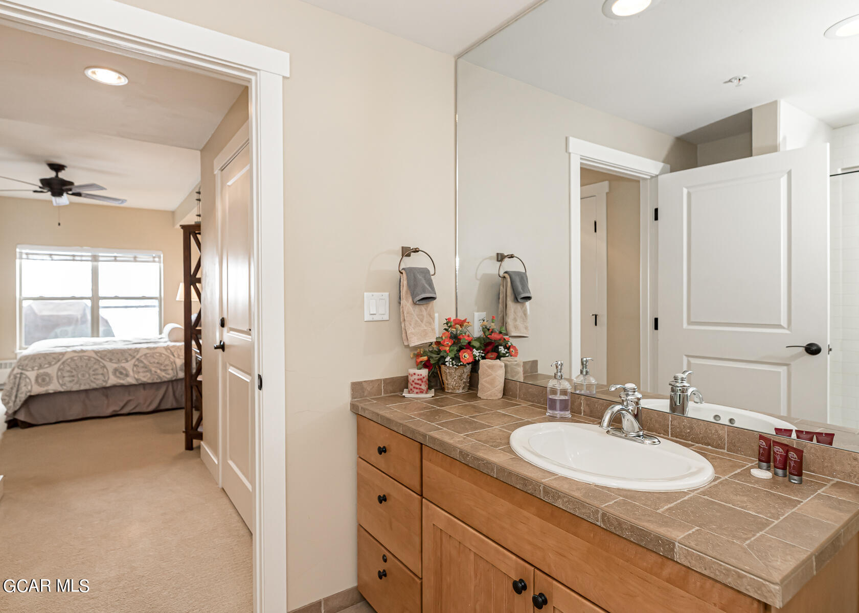 300 Base Camp Circle, Unit 208 Granby, CO 80446 - Photo 28 of 66 a en suite bathroom with a double vanity sink double mirror and bathtub