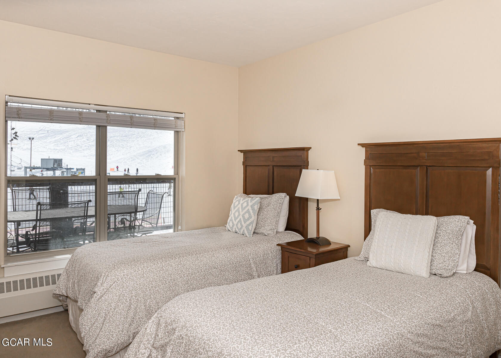 300 Base Camp Circle, Unit 208 Granby, CO 80446 - Photo 34 of 66 a bedroom with a large bed and a lamp next to a window