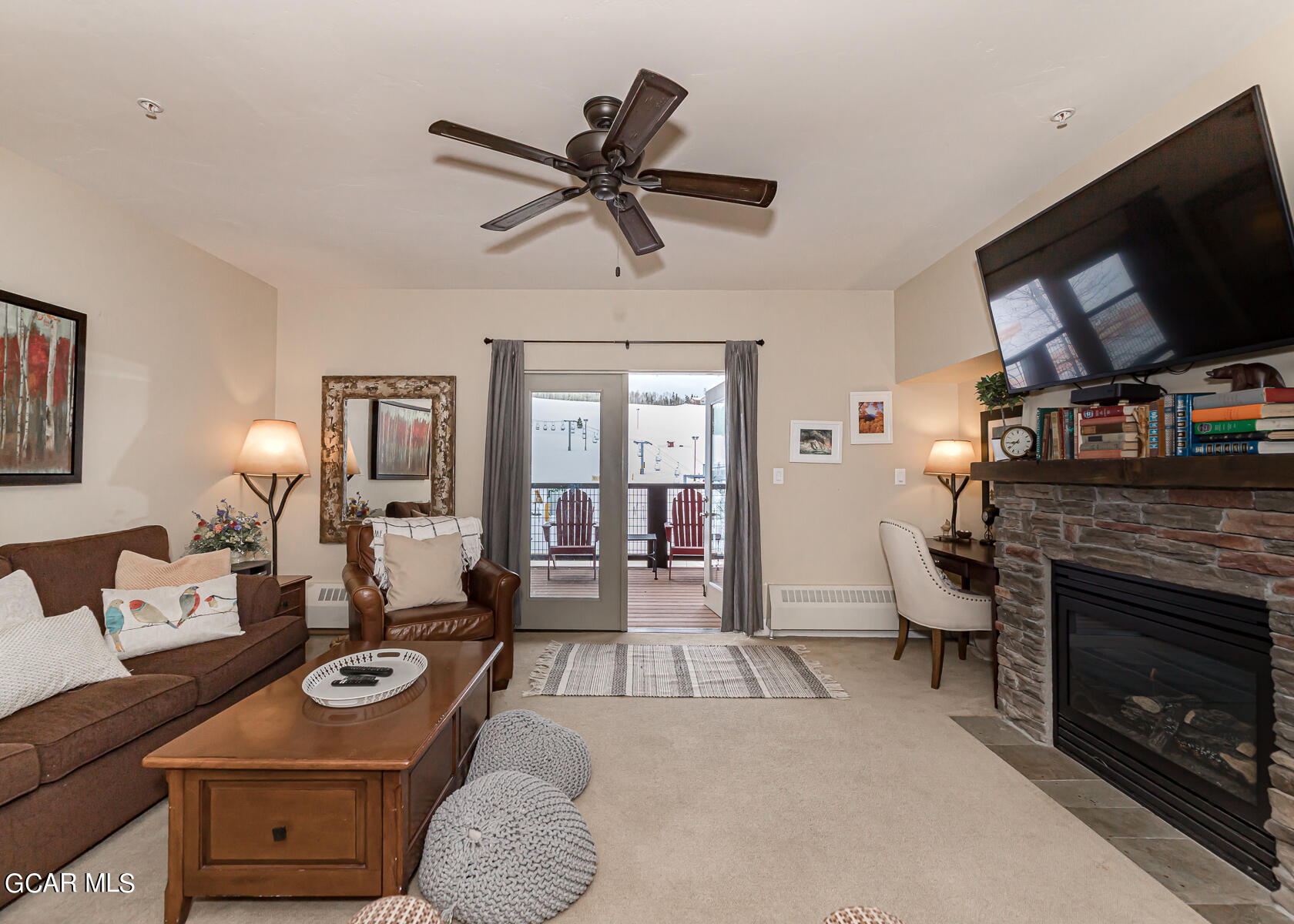 300 Base Camp Circle, Unit 208 Granby, CO 80446 - Photo 8 of 66 a living room with furniture and a flat screen tv