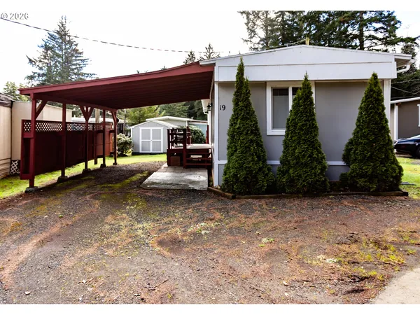 a backyard of a house with barbeque oven table and chairs
