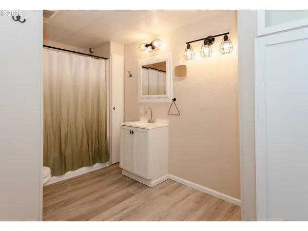 a bathroom with a toilet and a shower curtain