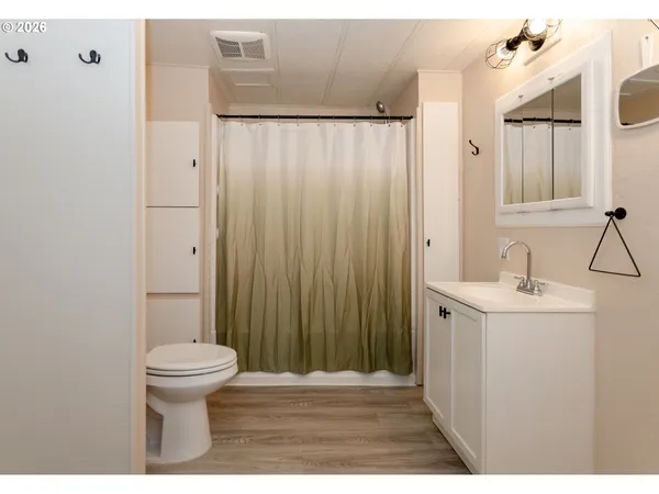 a view of an empty room with window and closet area