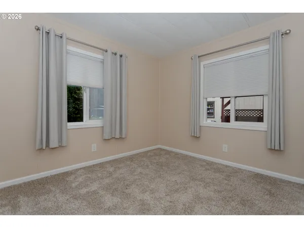 a view of an empty room and closet area