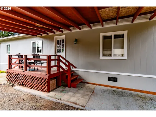 a view of a balcony with furniture and wooden floor