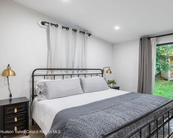 a bedroom with a large bed and a dresser