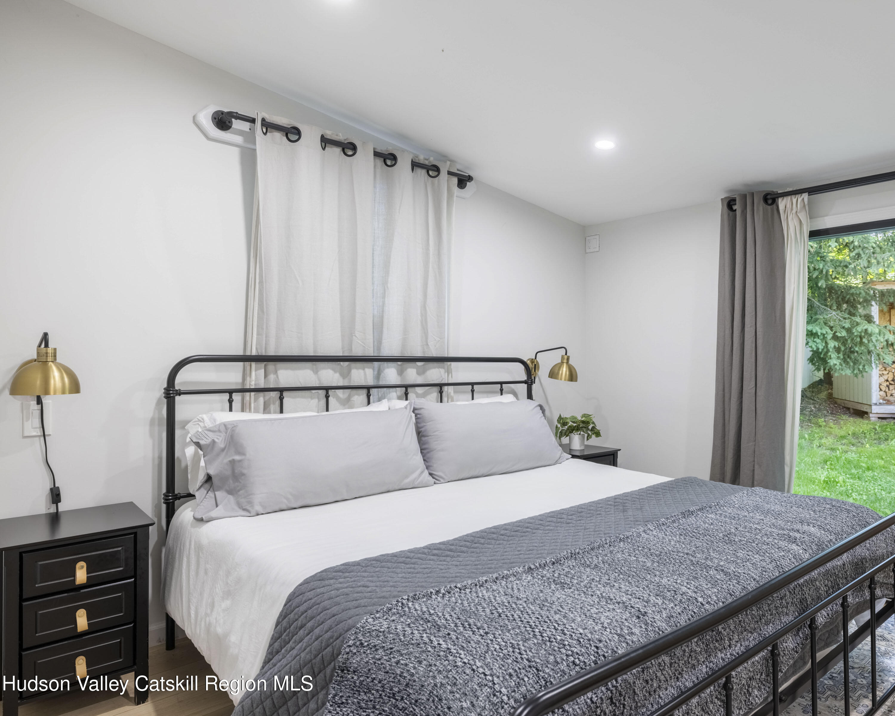 20 Sutton Hollow Road Windham, NY 12496 - Photo 14 of 30 a bedroom with a large bed and a dresser