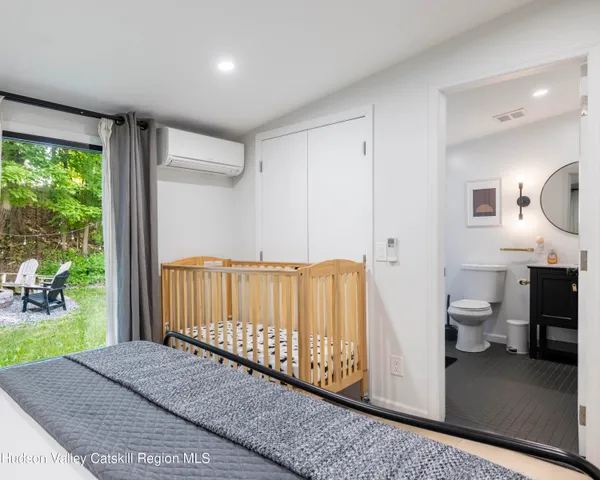 a bedroom with a bed and large window