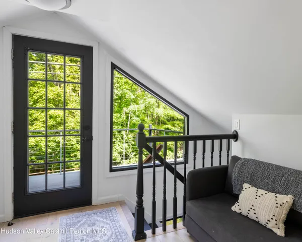 a view of a bedroom with furniture and a window