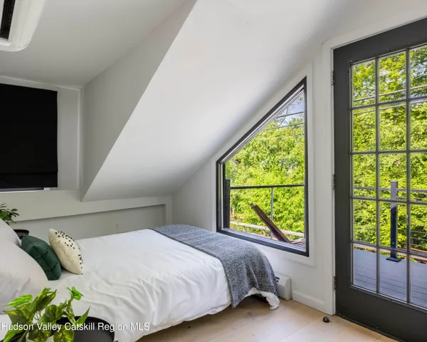 a bedroom with a bed and window