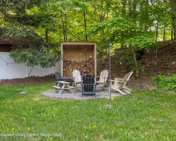 a view of a backyard with a garden and entertaining space