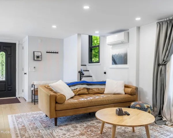 a living room with furniture and a potted plant
