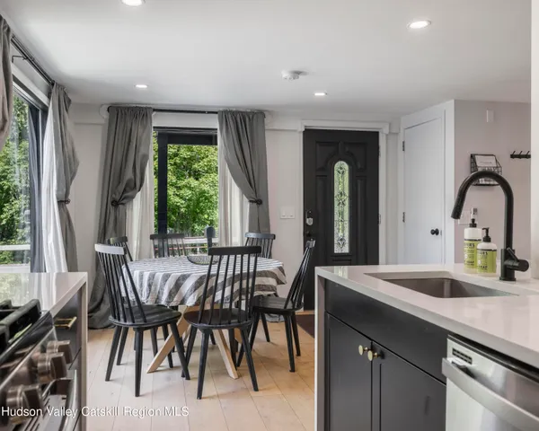a kitchen with a table chairs sink and cabinets