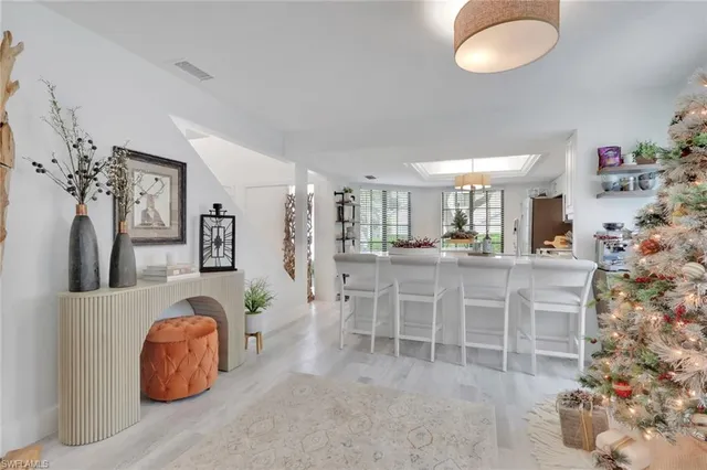 a dining room with furniture and a chandelier