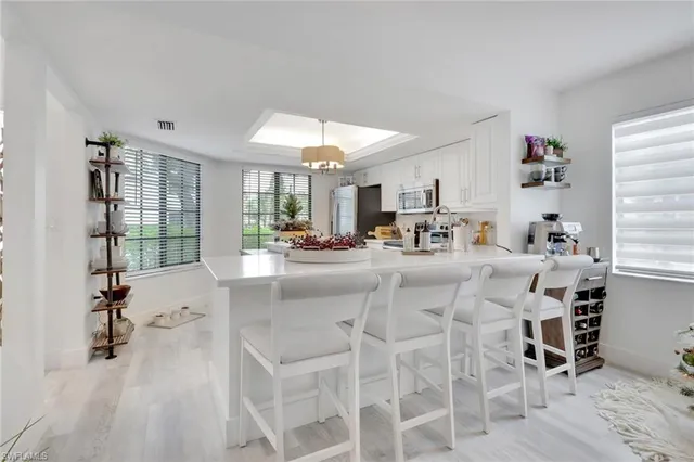 a kitchen with a sink cabinets and window