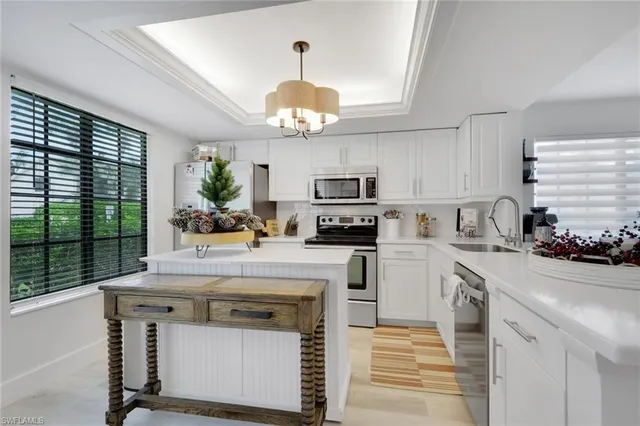 a kitchen with a stove a sink and a refrigerator