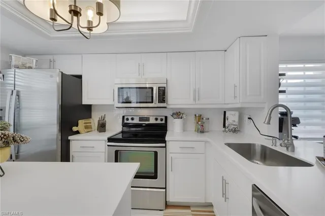 a kitchen with a sink a stove and refrigerator