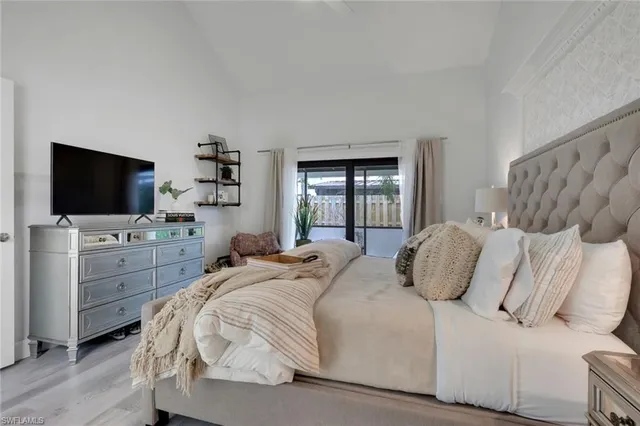 a bed room with bed and a large window