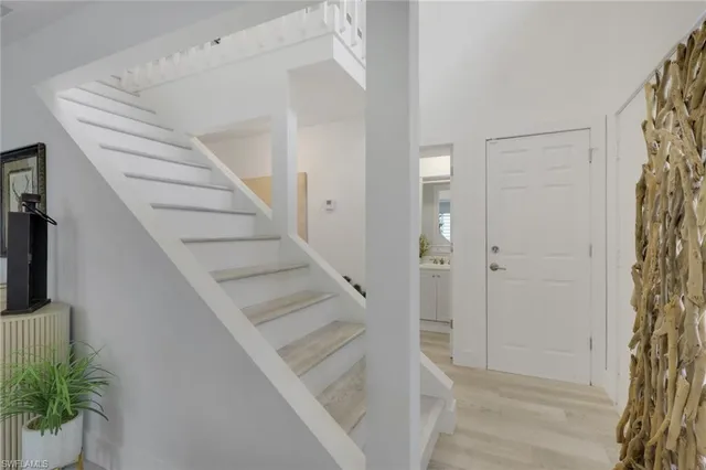 a view of entryway with wooden floor and stairs
