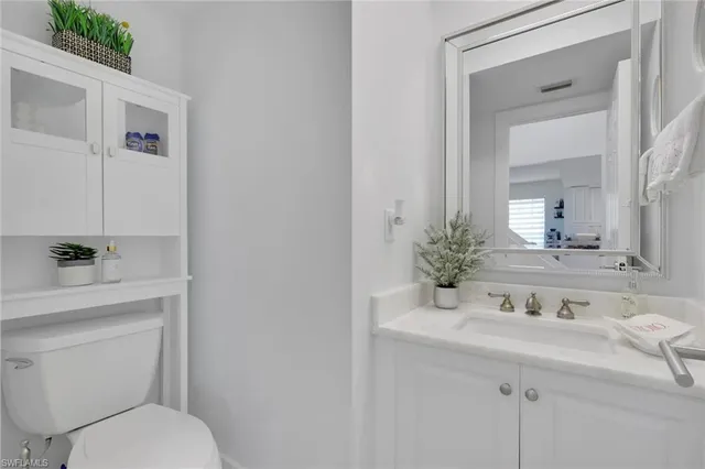 a bathroom with a sink toilet and mirror