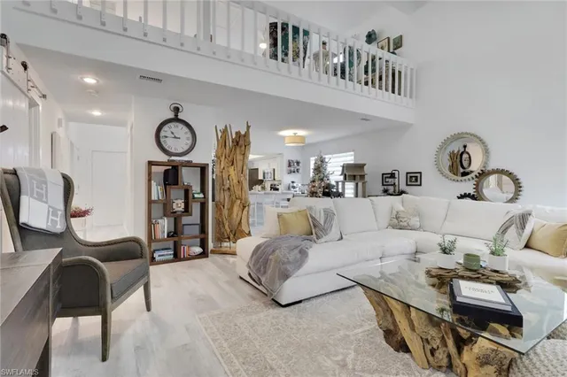 a living room with furniture a rug and a window