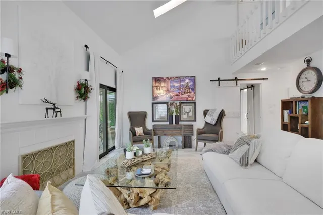 a living room with furniture a fireplace and a table