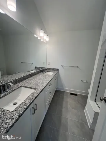 a bathroom with a glass shower door