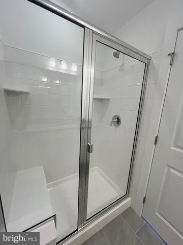 a storage room with wooden floor and white walls