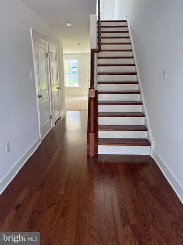 a view of a room with wooden floor