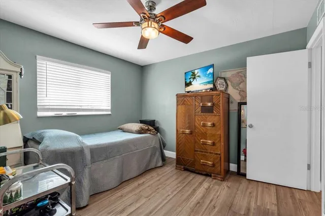 a living room with a bed furniture and a window