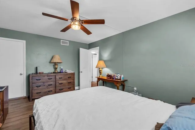 a bed room with a bed and a chandelier