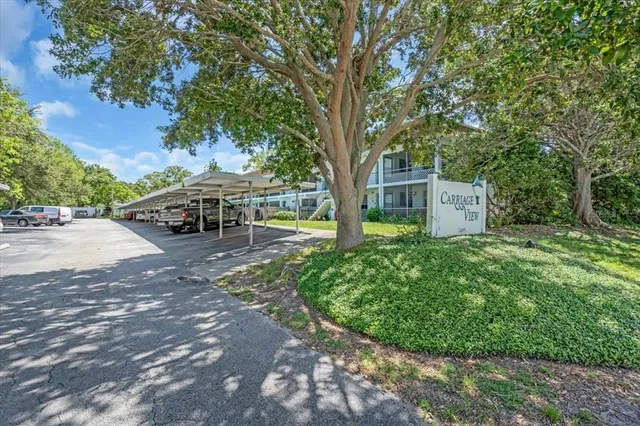 a view of a house with backyard and sitting area