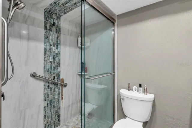 a bathroom with a toilet sink and shower