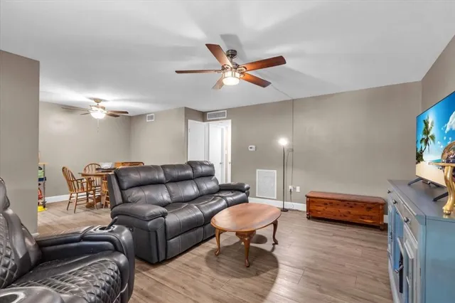 a living room with furniture and a wooden floor