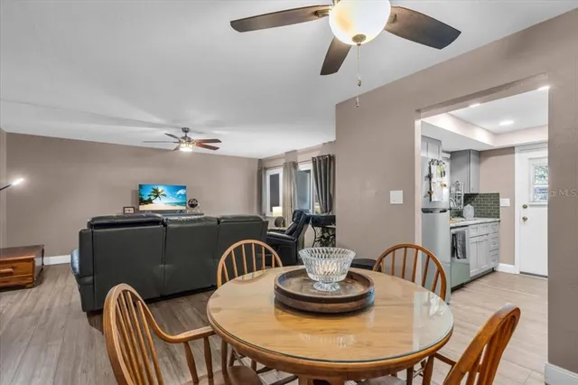a dining room with furniture and wooden floor