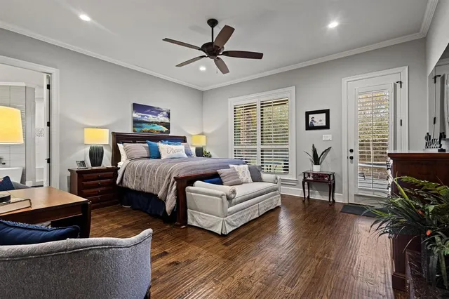 a bedroom with a bed wooden floor and furniture