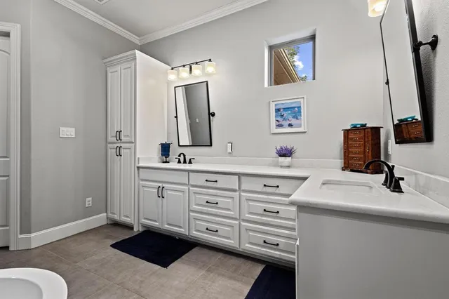 a bathroom with a sink vanity granite tub and a mirror