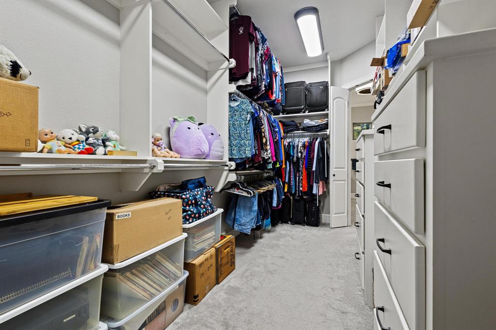 57 Arboretum Denison, TX 75020 - Photo 18 of 40 a view of walk in closet with clothes and shoes