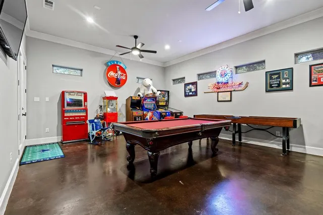 a room with furniture pool table and windows
