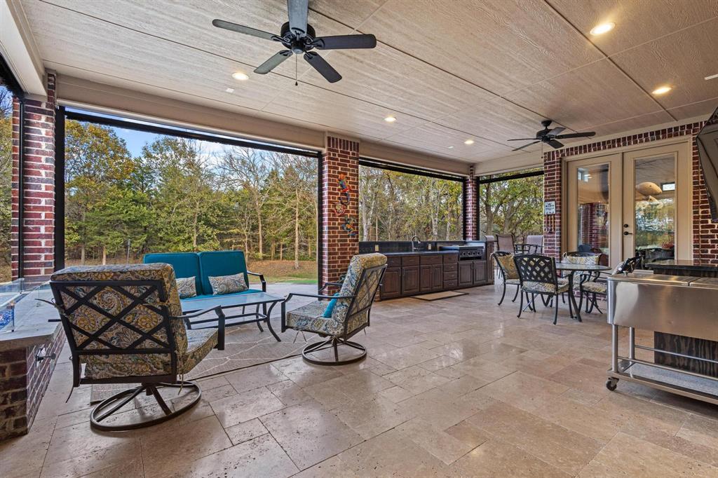 57 Arboretum Denison, TX 75020 - Photo 28 of 40 a living room with furniture a flat screen tv and a large window