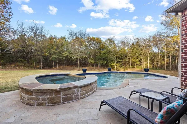 a view of a swimming pool with a patio