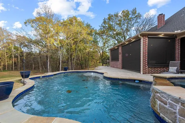 a view of a swimming pool with a patio