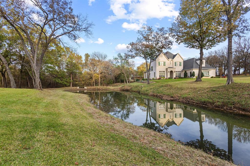 57 Arboretum Denison, TX 75020 - Photo 37 of 40 a view of a lake with a yard and large trees