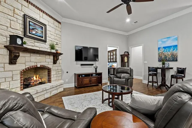 a living room with furniture a fireplace and a flat screen tv