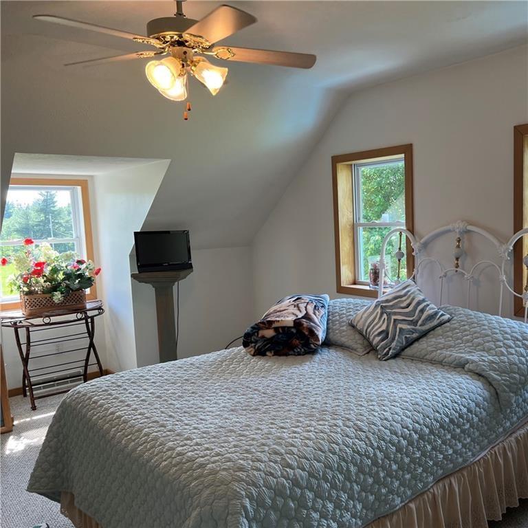 32753 Teepleville Road Centerville, PA 16404 - Photo 17 of 24 a bedroom with a bed and a chandelier