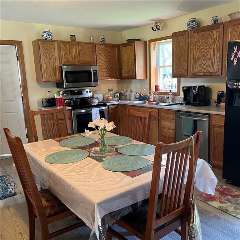 32753 Teepleville Road Centerville, PA 16404 - Photo 8 of 24 a kitchen with stainless steel appliances granite countertop a kitchen island hardwood floor a dining table and chairs
