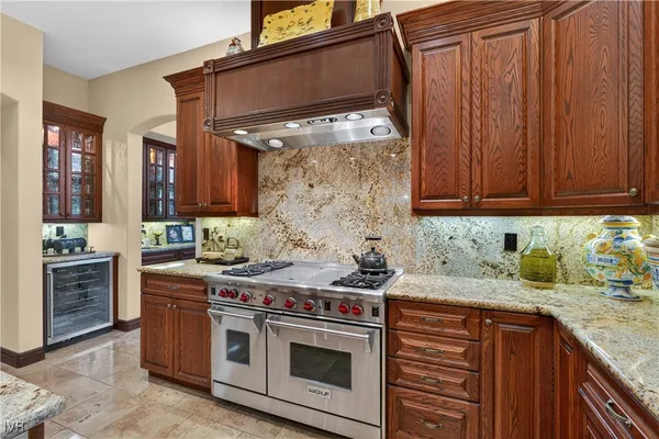 a large kitchen with kitchen island a large window in it